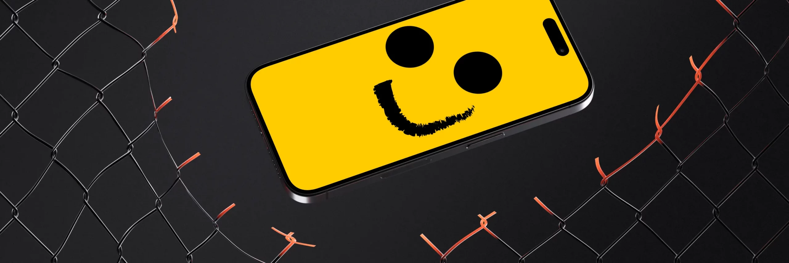 Smartphone mit einem gelben Smiley-Gesicht auf dem Display, umgeben von einem schwarzen Zaun mit roten Bindfäden